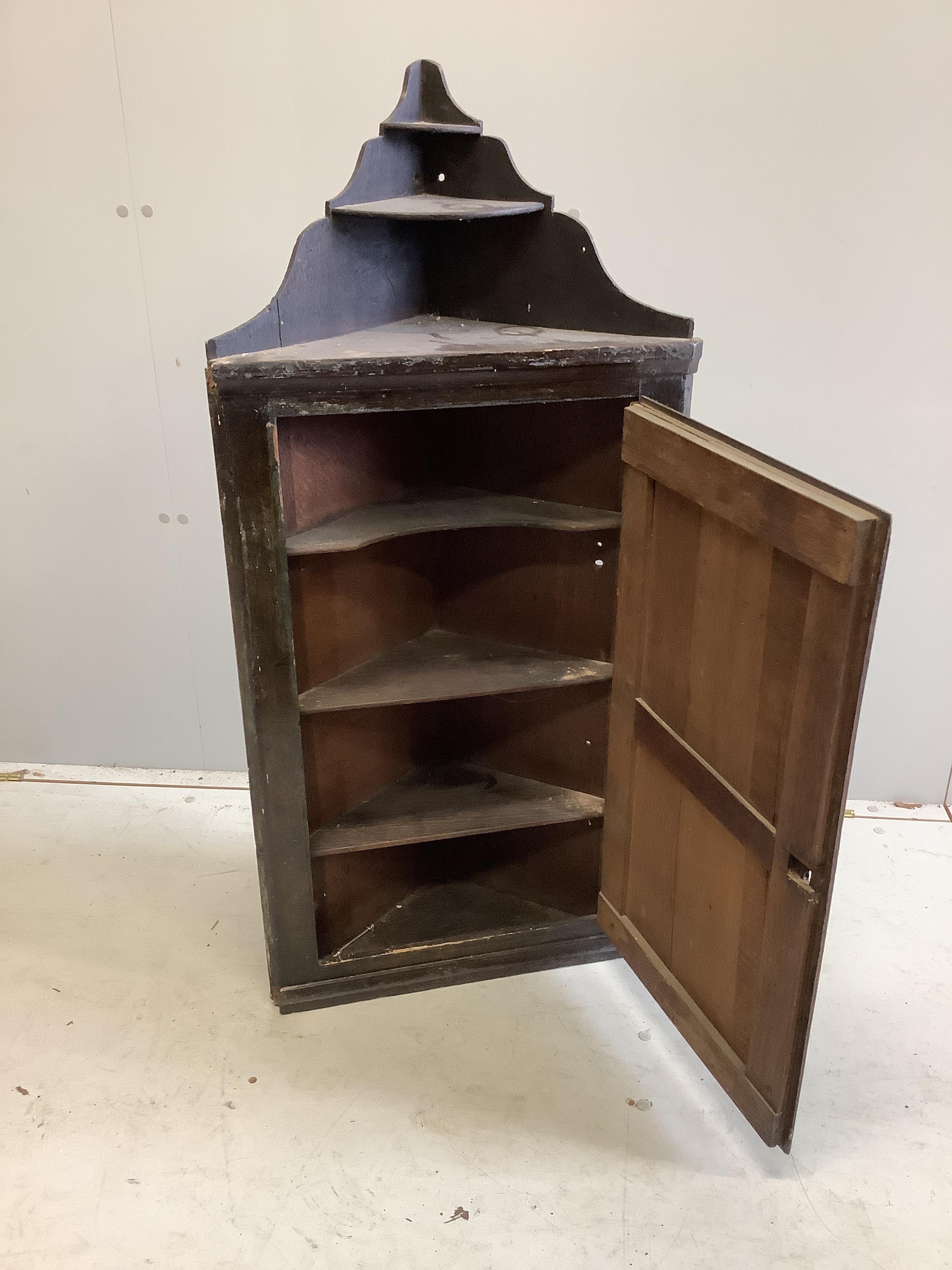 An 18th century painted hanging corner cupboard, width 50cm, depth 22cm, height 107cm